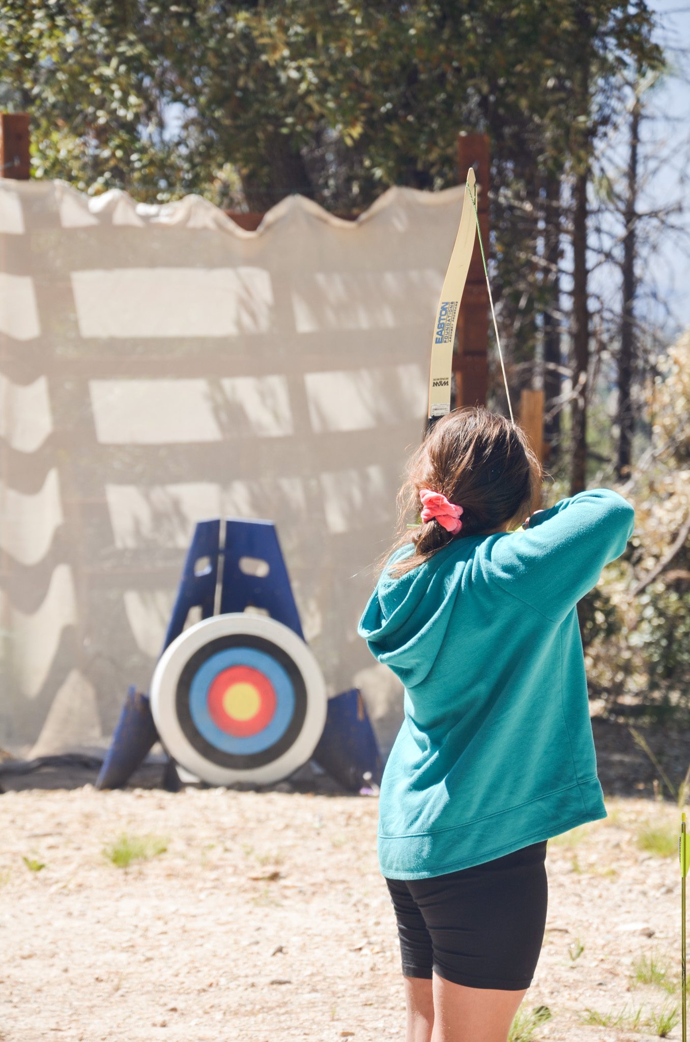 girl scout with bow at archery range