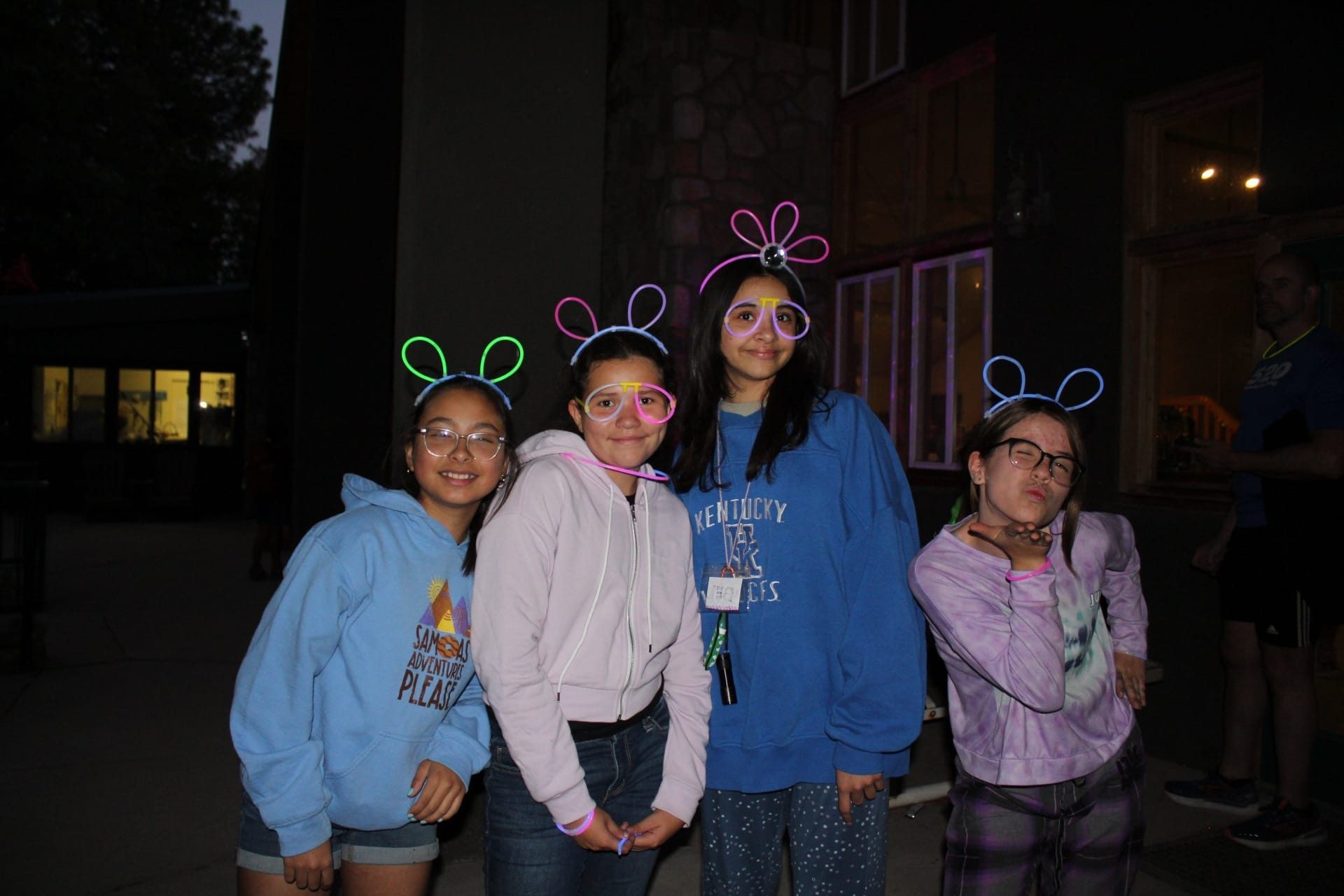 girl scouts at camp having fun with glow sticks