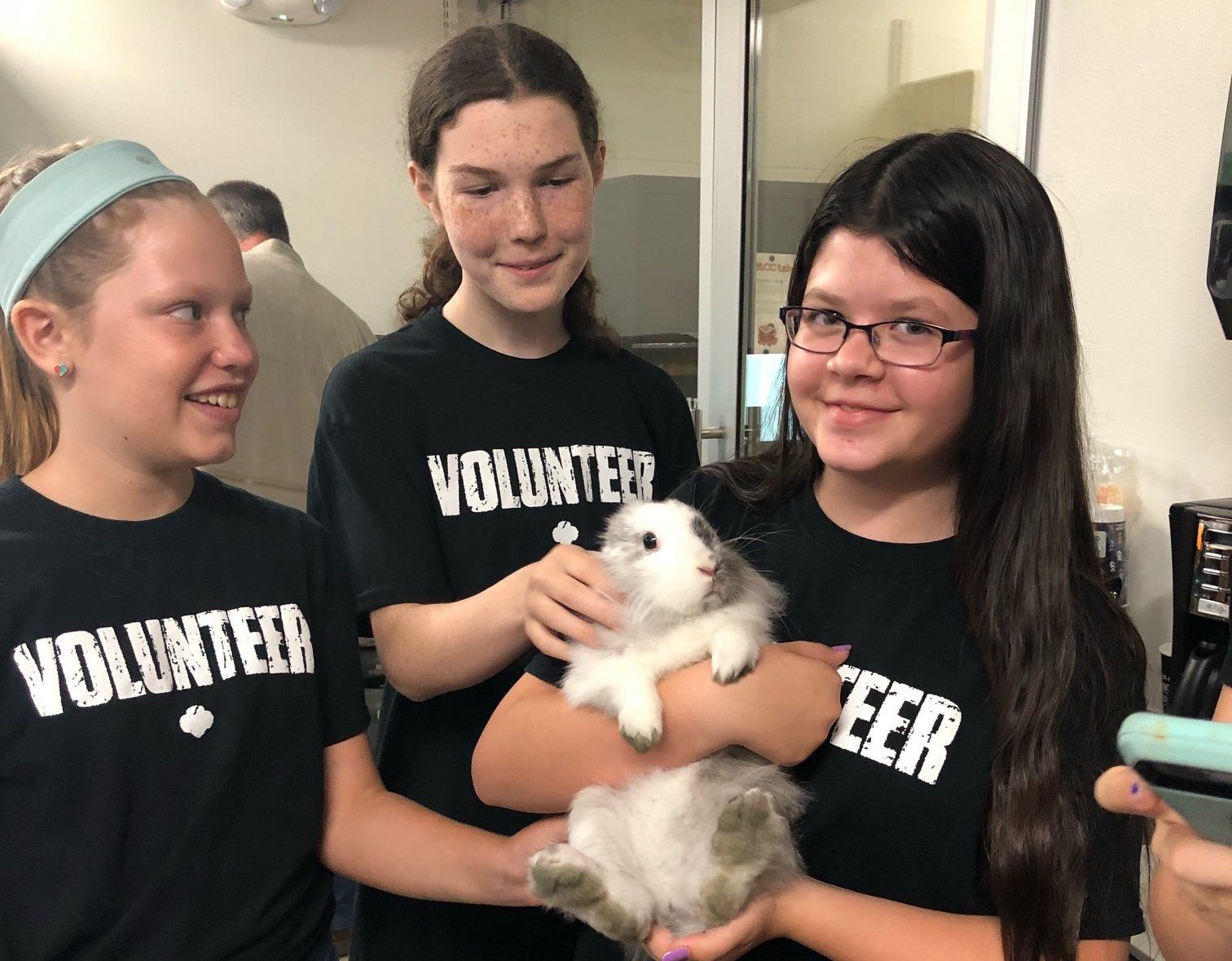 gvc girl scouts holding a rabbit at an animal shelter