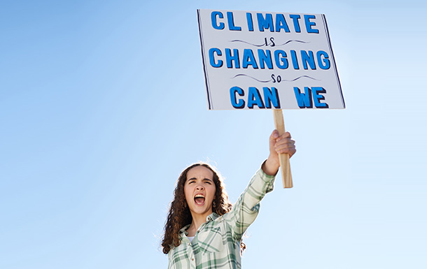 girl scout holding climate change sign