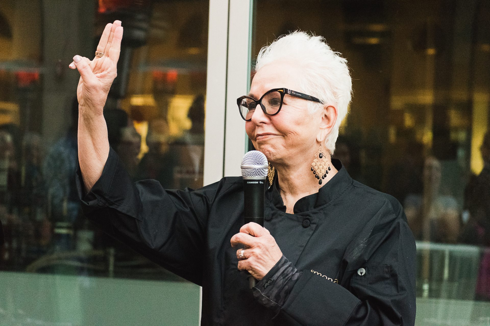 carlotta flores making the girl scout hand sign at cookies and cocktails event