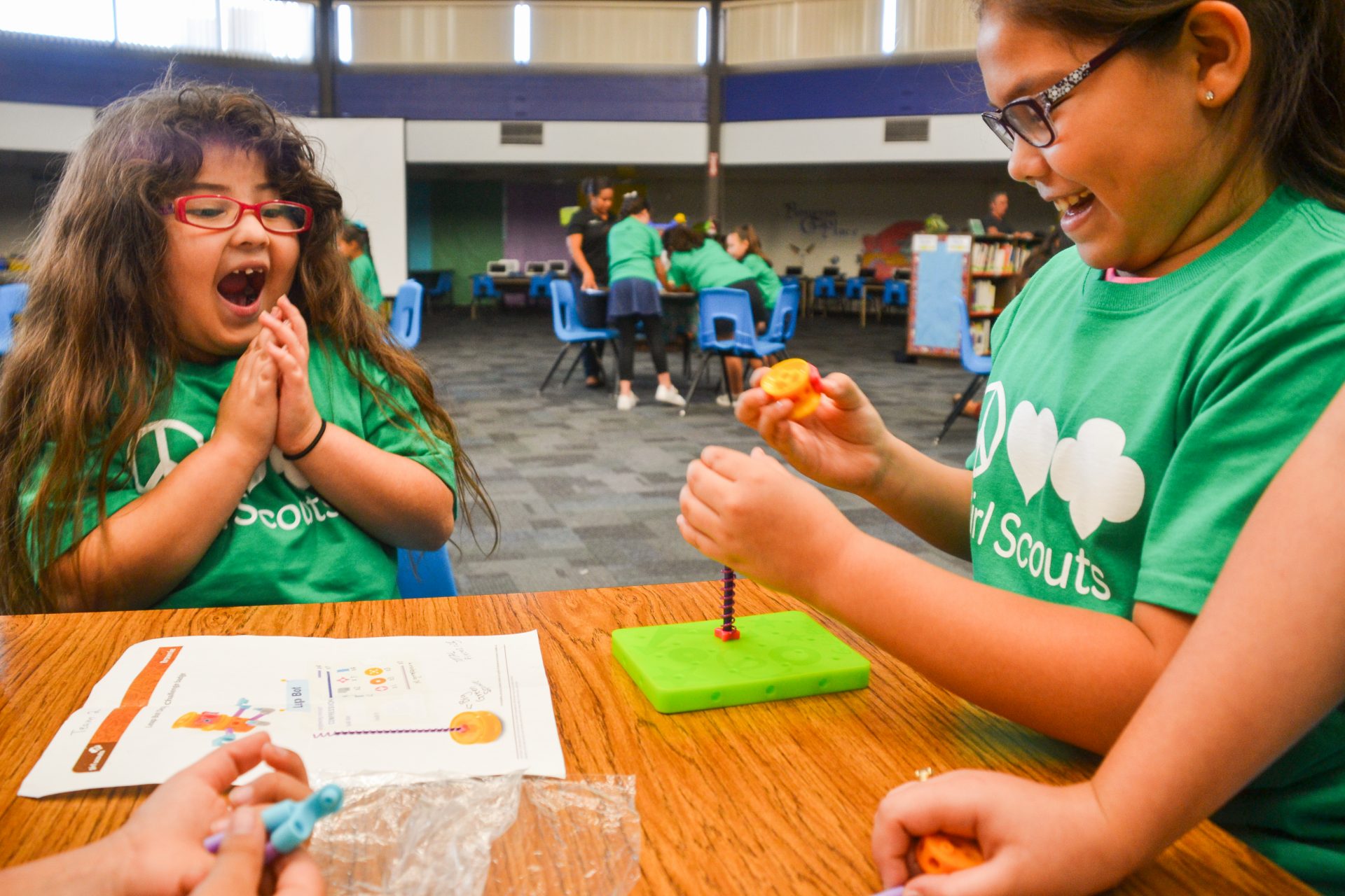 girl scouts joyfully participating in a stem activity