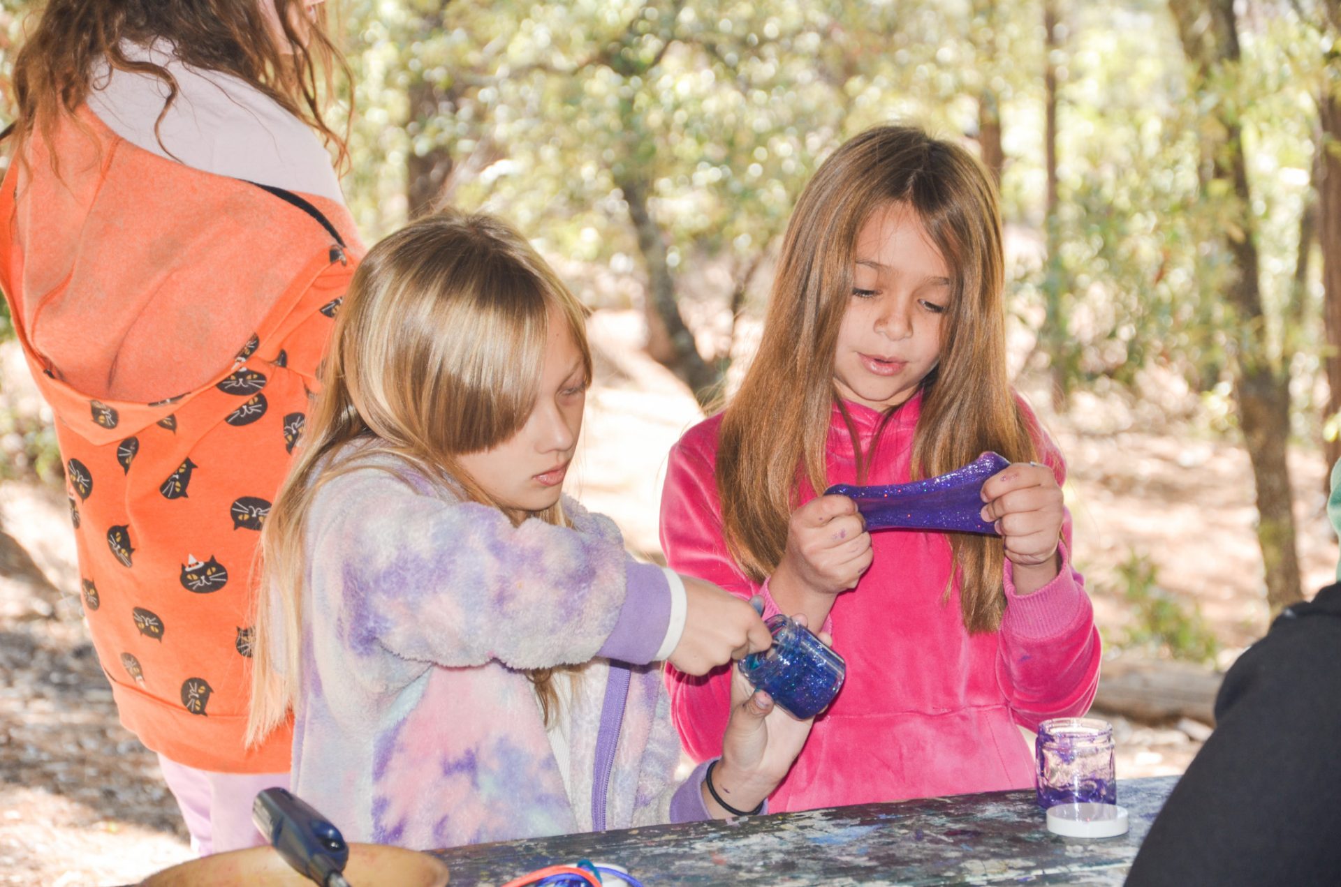 girl scouts making slime at camp