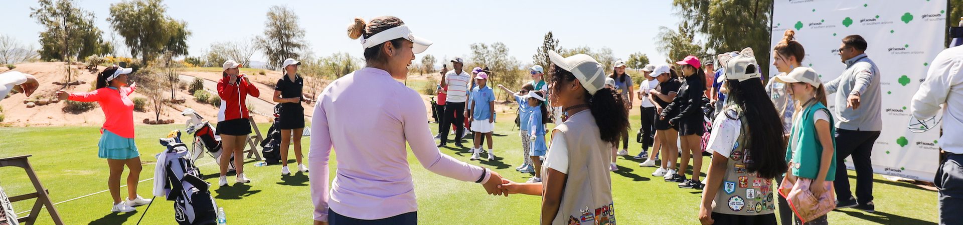  girl scout and pro golfer shaking hands 