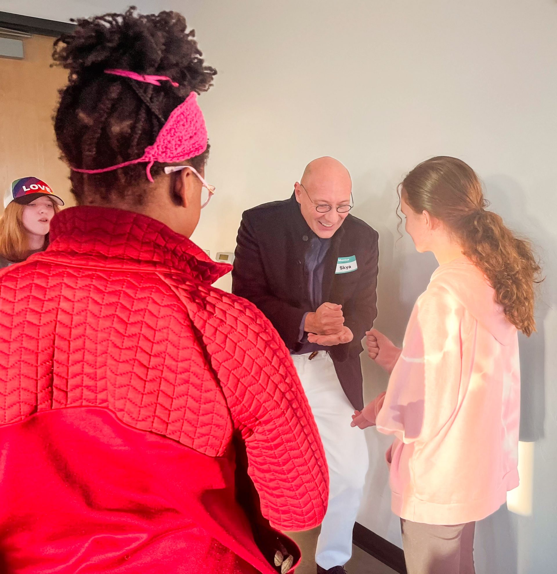 girl scout playing rock, paper, scissors with a community partner