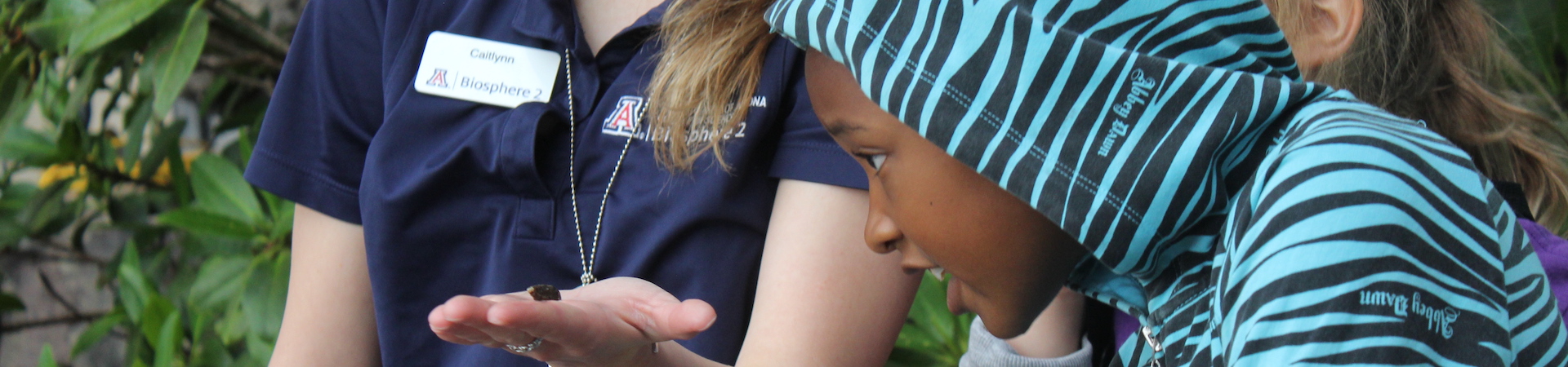  biosphere employee showing girl scouts a specimen 