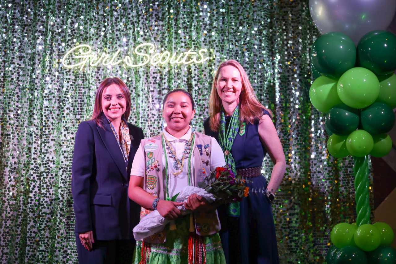 ceo and board chair posing with girl scout