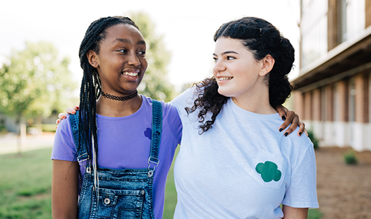 ceo and board chair posing with girl scout