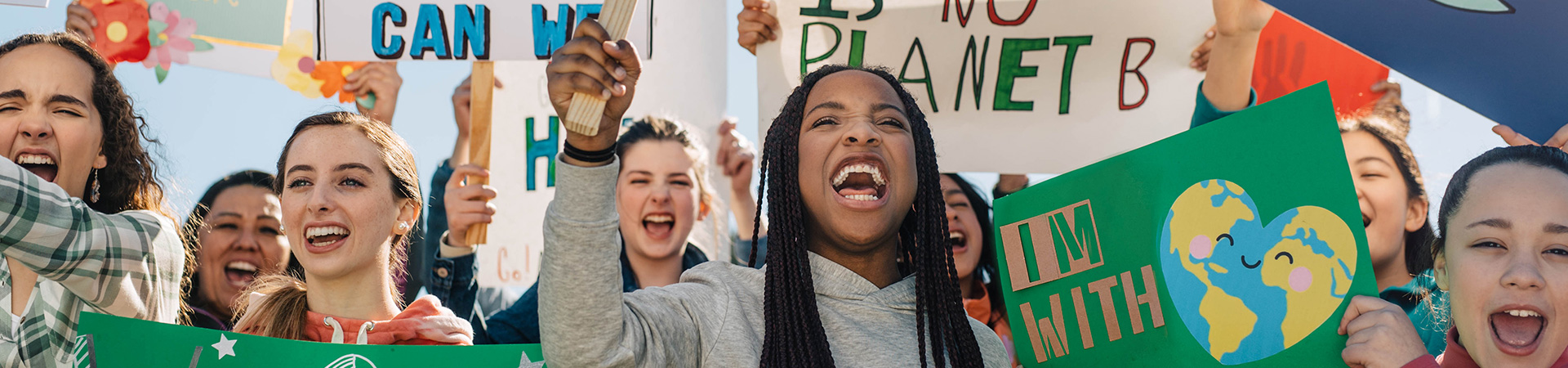  girl scouts with posters 