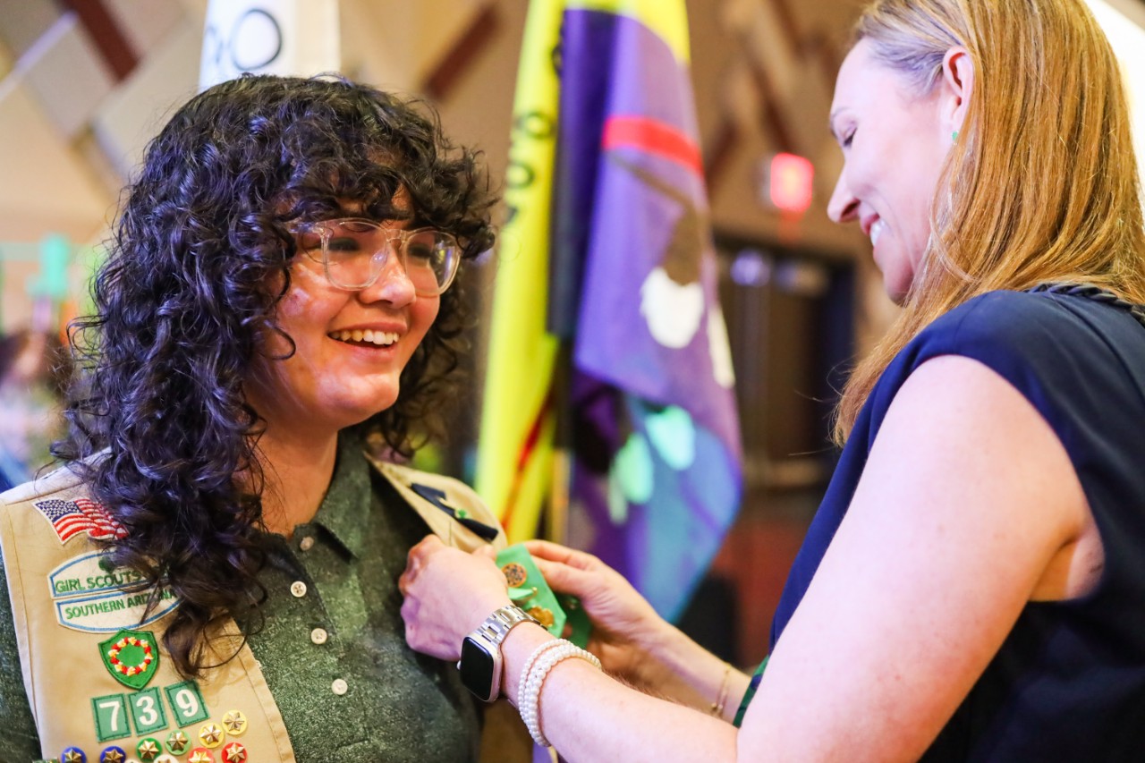 girl board member being pinned by board chair