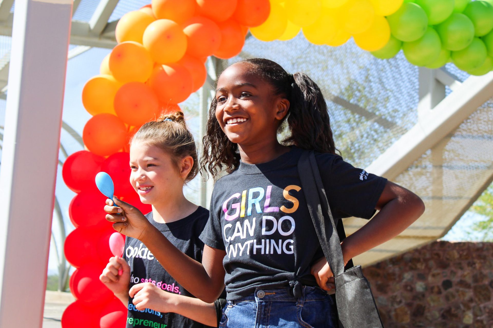 girl scouts smiling with balloons