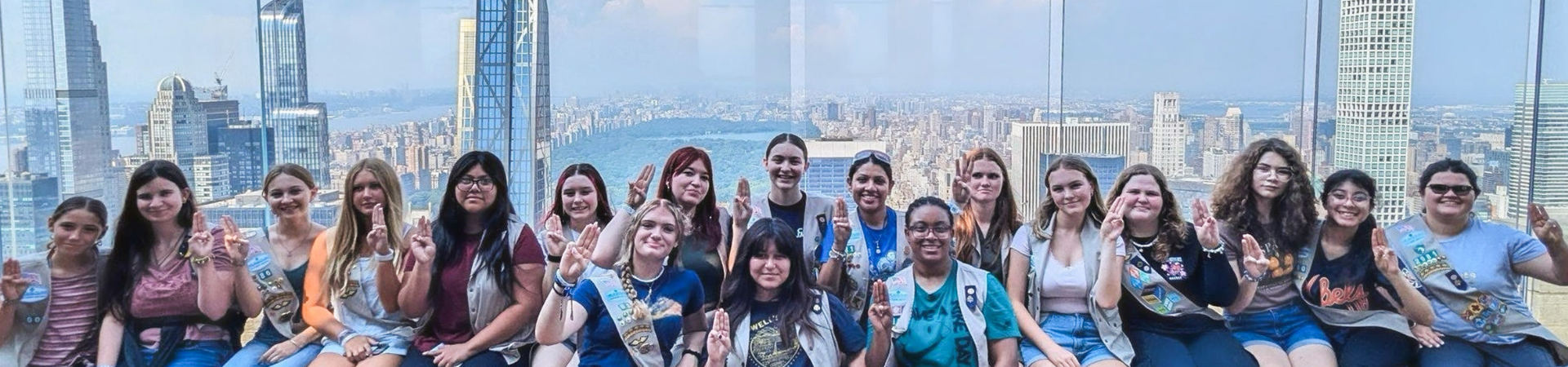  girl scouts with arms around one another looking at sydney opera house as a result of their cookie reward 