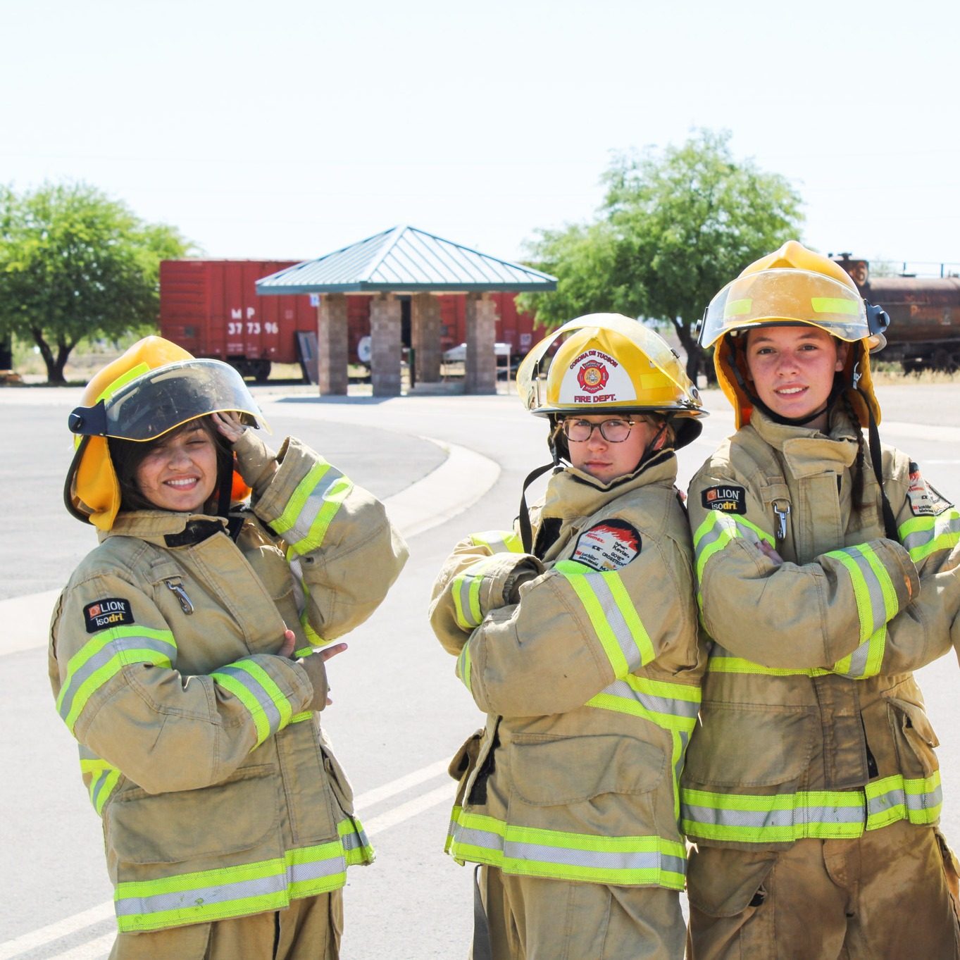 sara sloughfy posing with other camp fury girl scouts dressed in firefighter gear