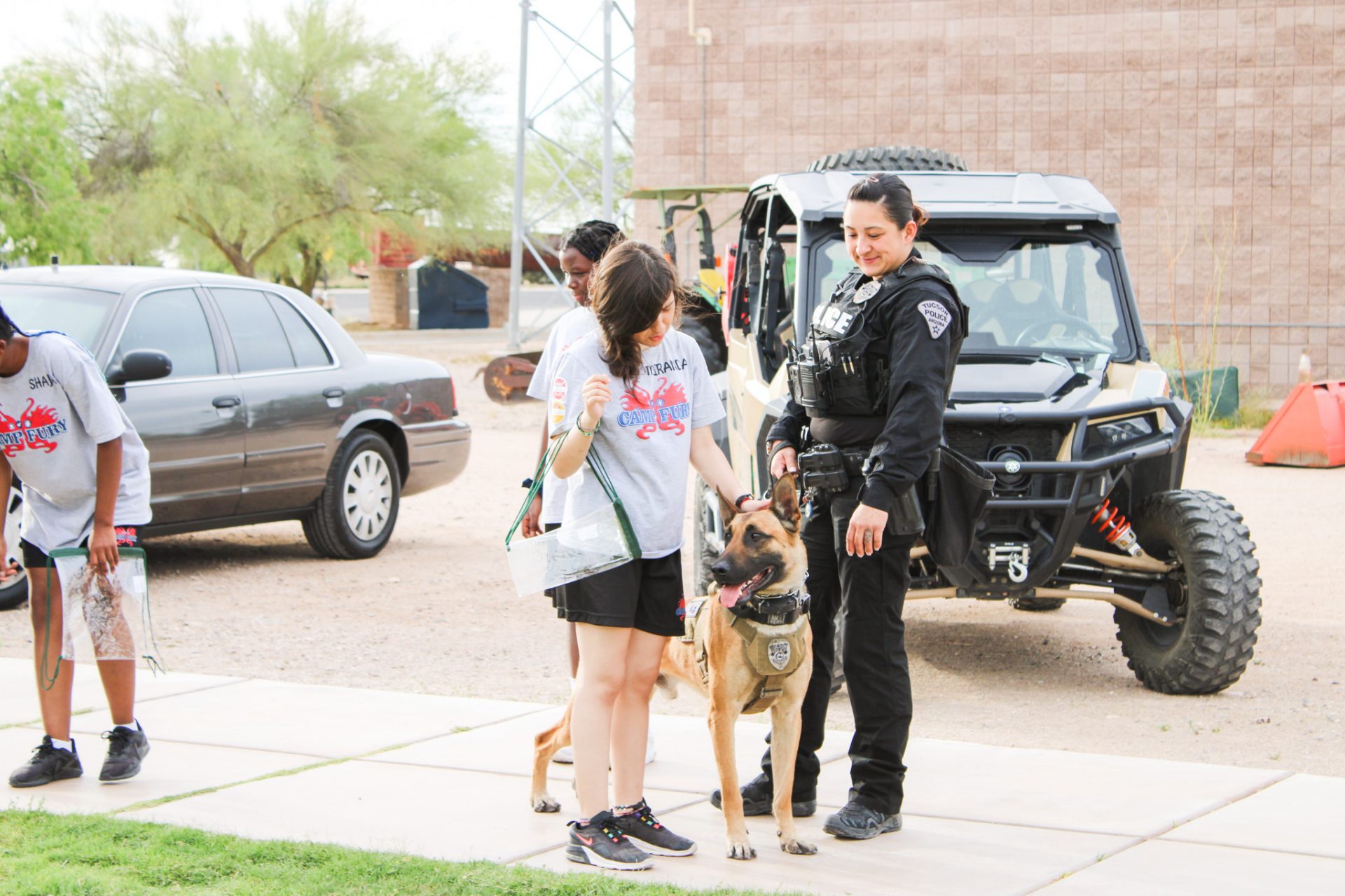 girl scout petting police dog