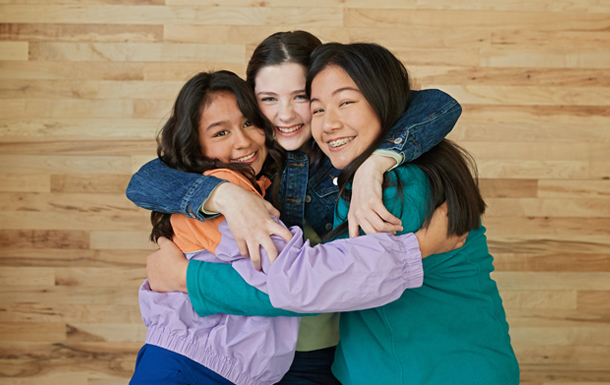 Three girls hugging