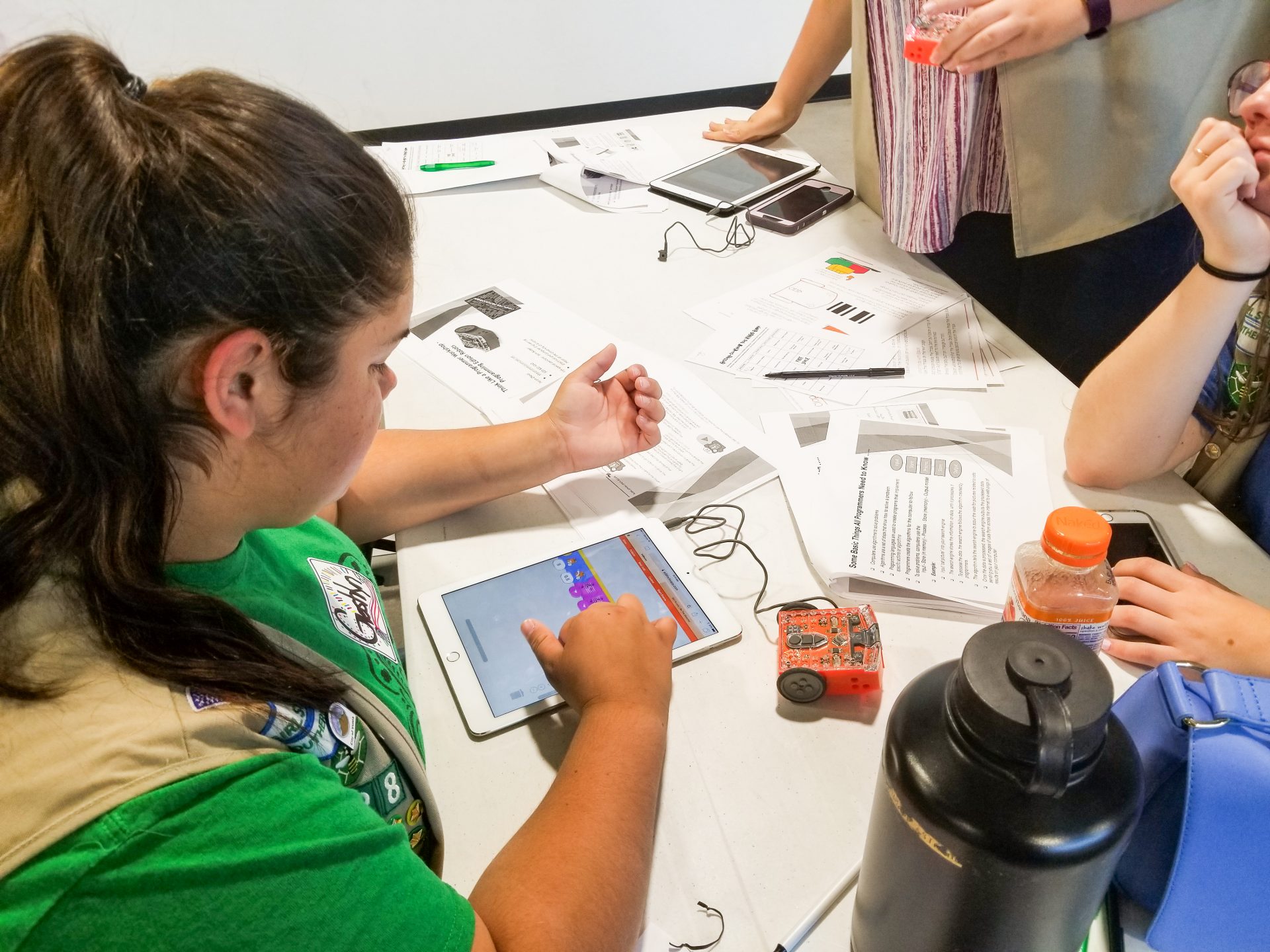 girl scout with ipad powering a robotic mechanism
