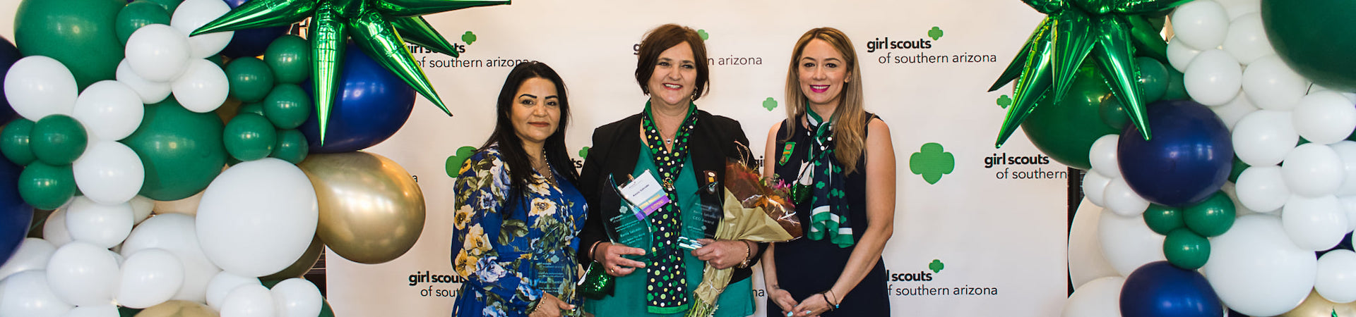  staff and volunteers posing at an event 