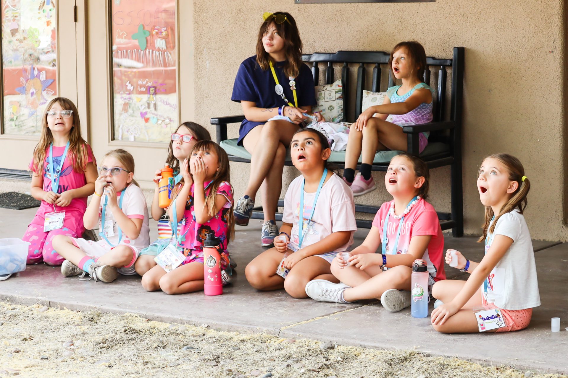 girl scouts at camp watching a rocket science experiment 