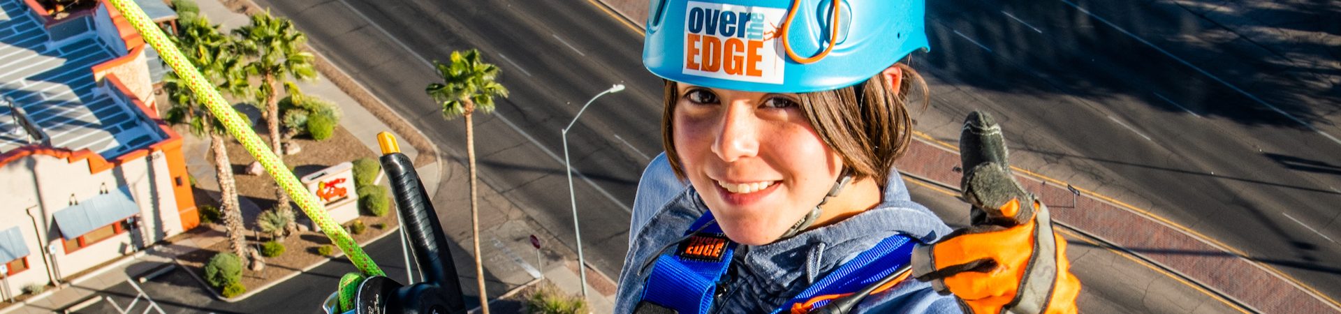  over the edge participant smiling atop the 5151 building 