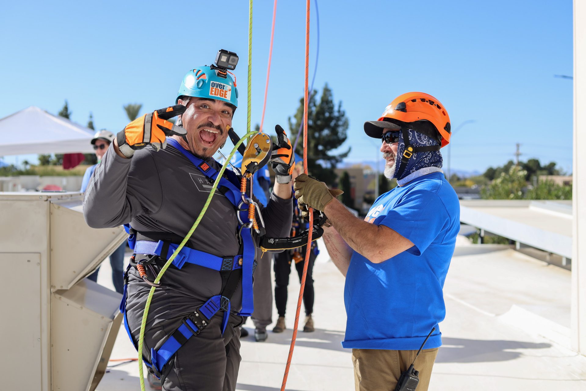 rope volunteer helping over the edge participant