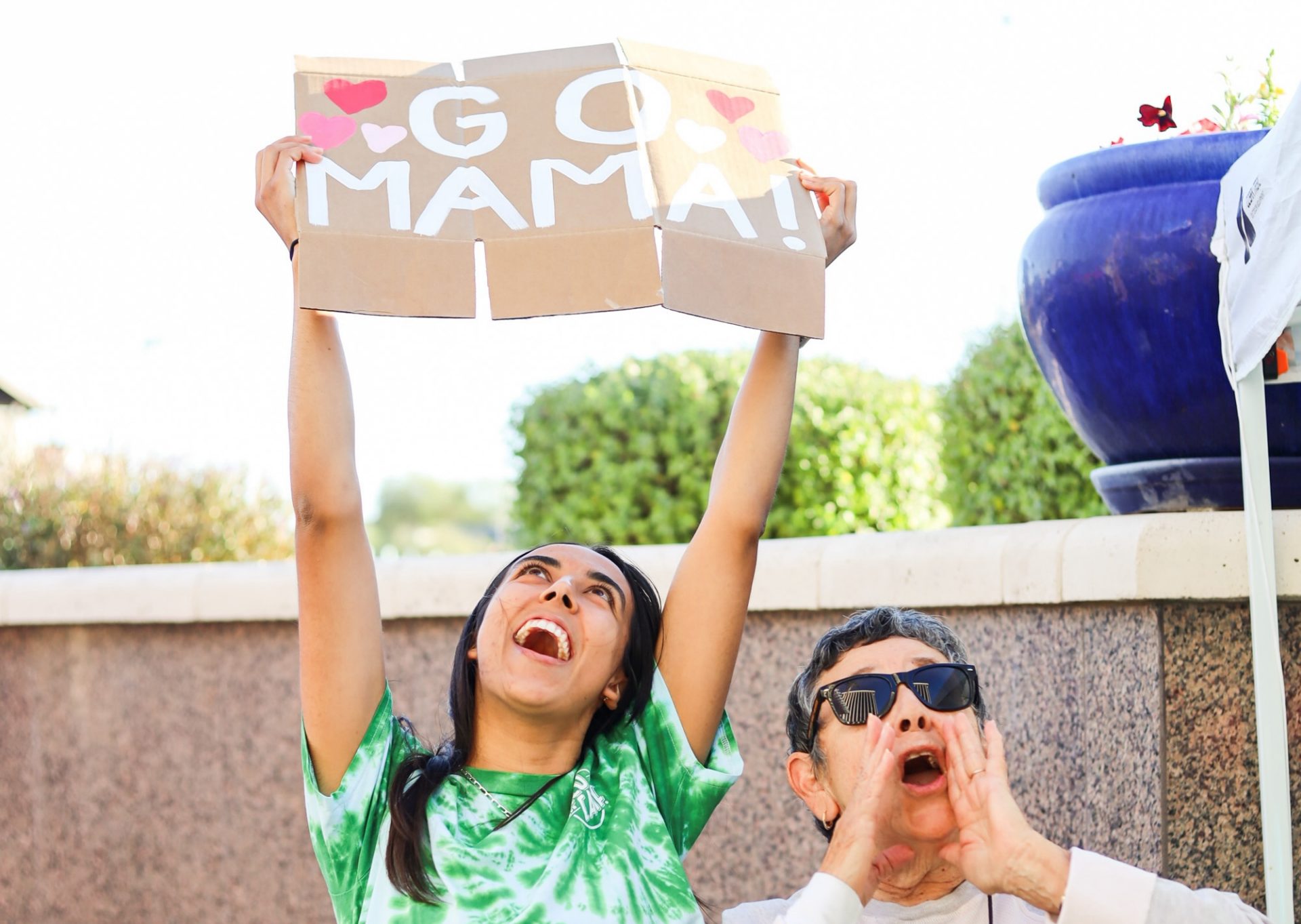 family cheers on rappeller at over the edge